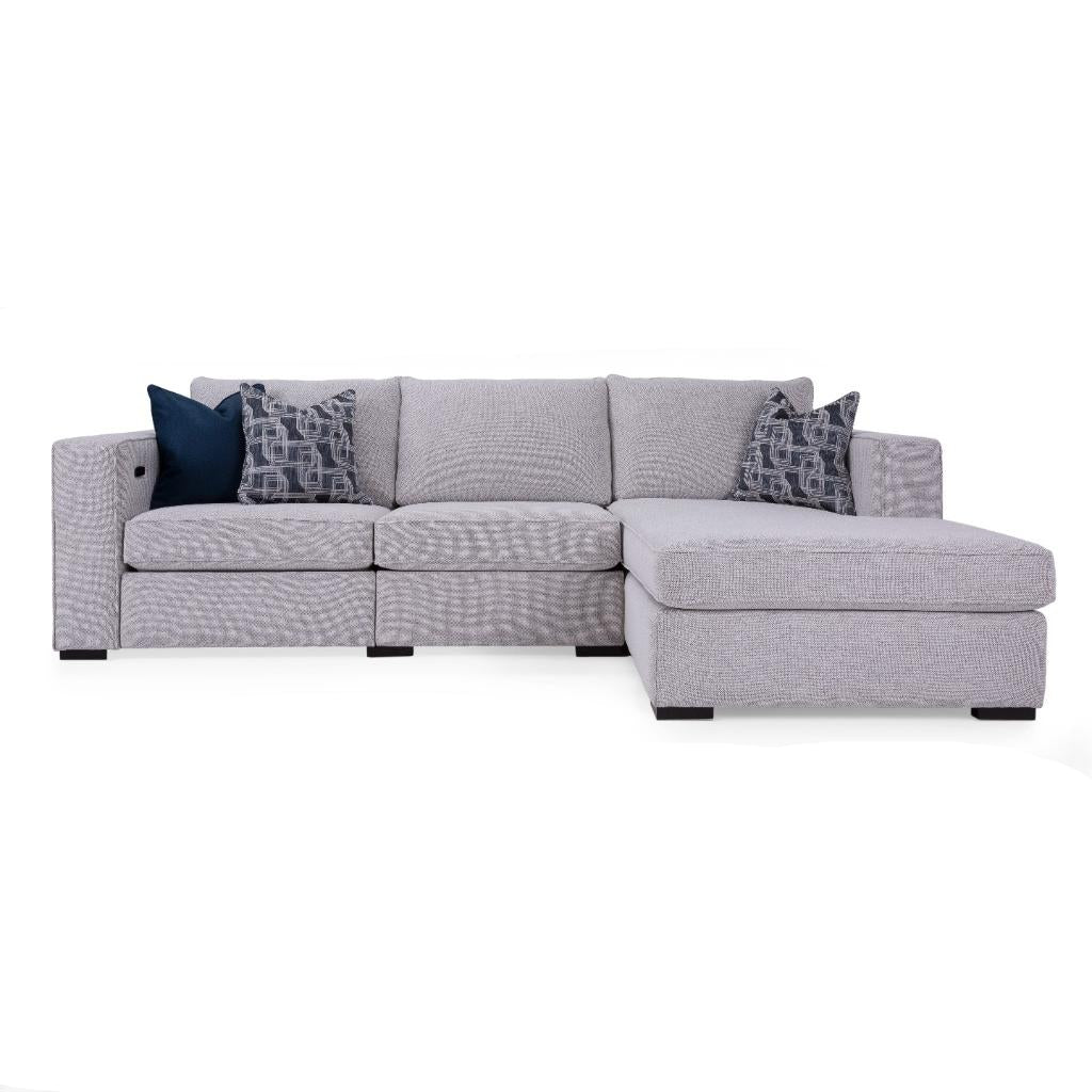 Gray sectional sofa with patterned cushions on a white background