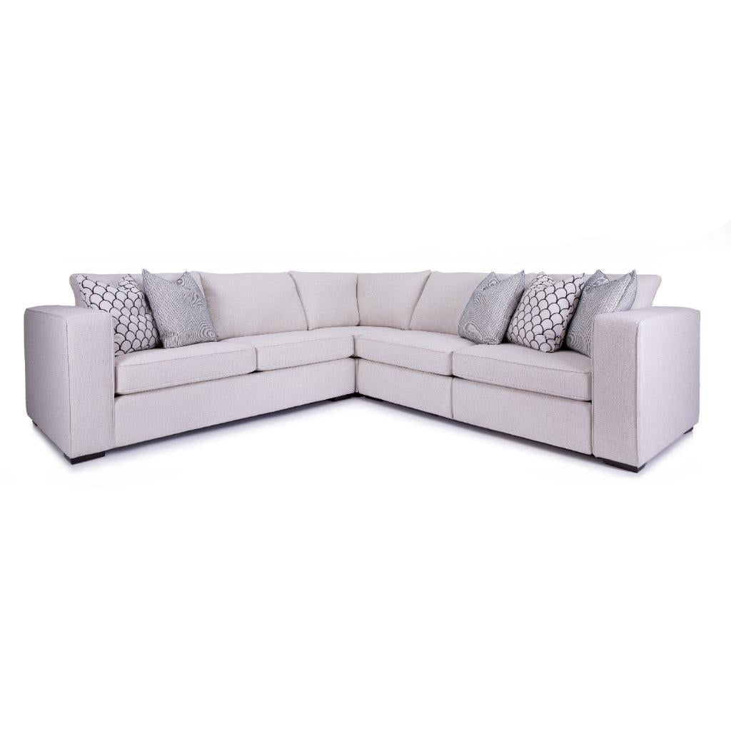 Gray sectional sofa with patterned cushions on a white background