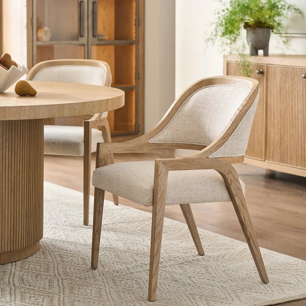 Wooden chair and dining table in a room with wooden cabinets and a rug.