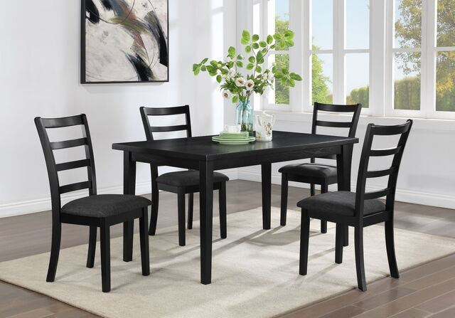 Black dining table set with chairs in a room with large windows.