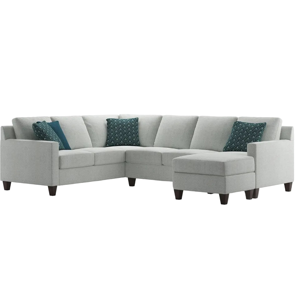 Gray sectional sofa with blue patterned cushions on a white background