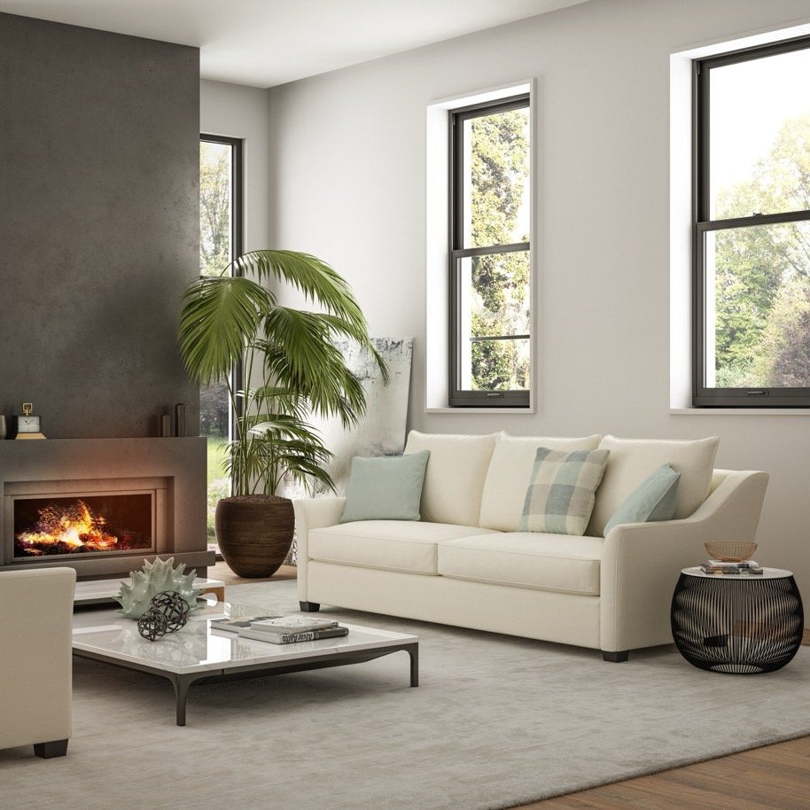 Modern living room with a fireplace, white sofa, and armchair.