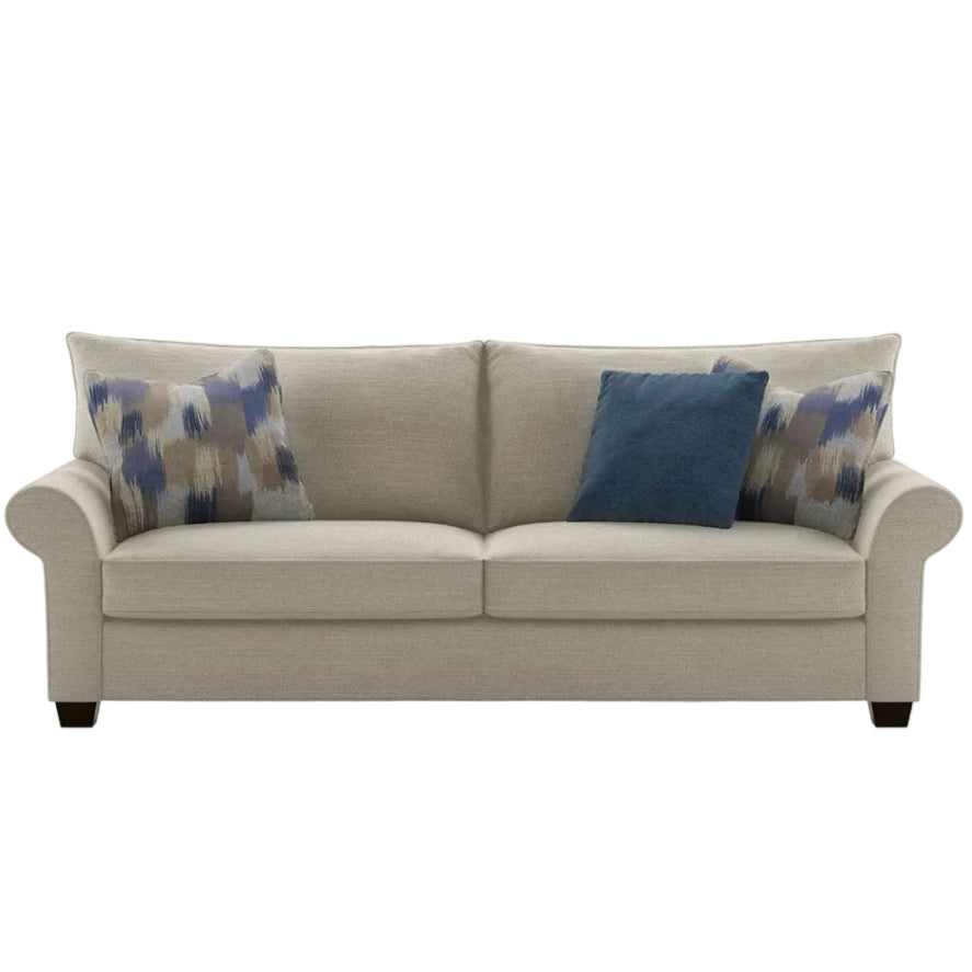 Beige sofa with blue and abstract-patterned cushions on a white background