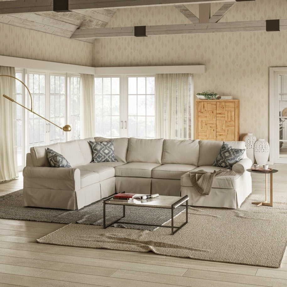 Modern living room with a sectional sofa, coffee table, and decorative items.