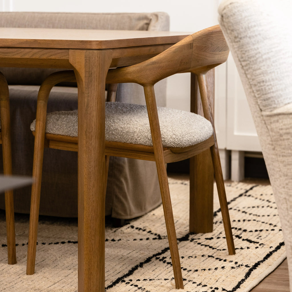 Wooden dining table with chairs in a room setting