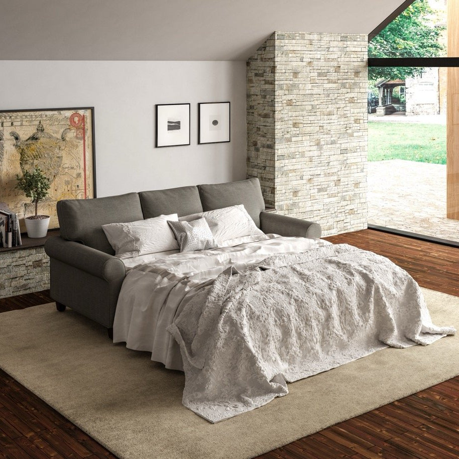 Modern bedroom with gray sofa bed, white bedding, and large windows.