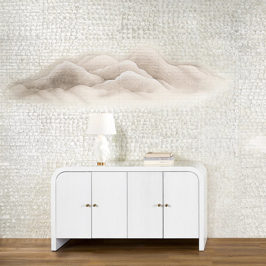 White cabinet against a textured wall with cloud-like designs