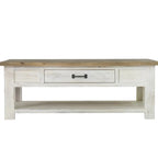 Wooden coffee table with a white washed base and wooden top on a white background