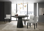 Modern dining room with a black round table and gray chairs.