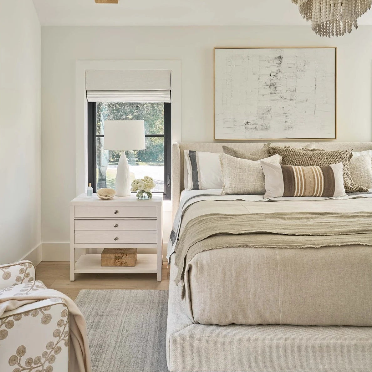 Neatly arranged bedroom with a bed, nightstands, and decor.