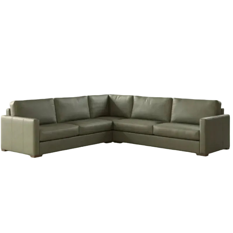 Green sectional sofa on a white background