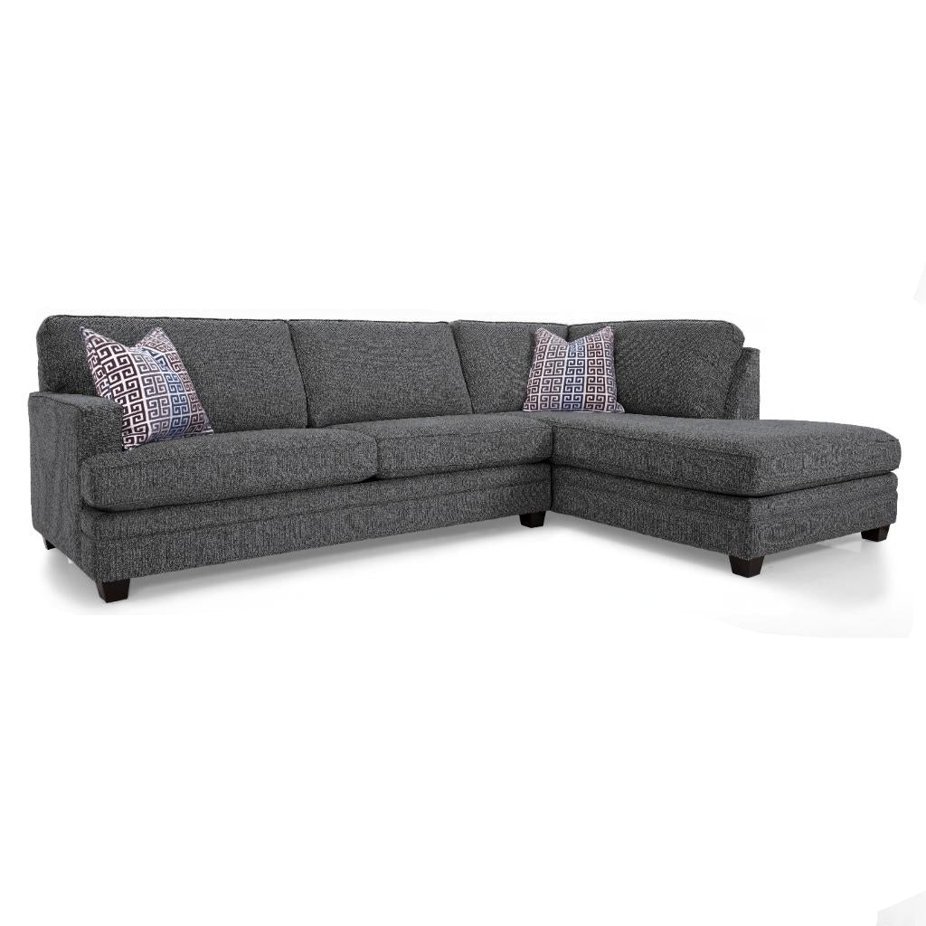 Gray sectional sofa with patterned cushions on a white background