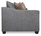 Gray upholstered chair with two pillows on a white background