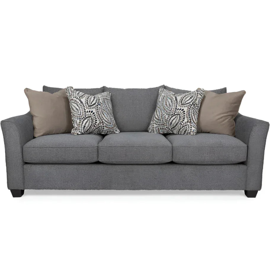 Gray sofa with patterned and solid cushions on a white background