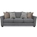 Gray sofa with patterned and solid cushions on a white background
