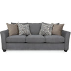 Gray sofa with patterned and solid cushions on a white background