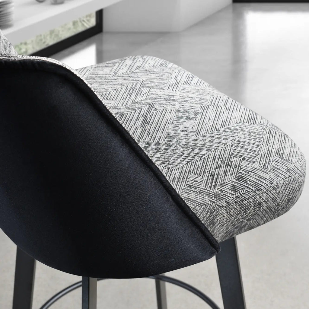 Bar stool with black seat and gray patterned backrest in a modern kitchen setting.