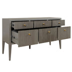 Gray dresser with multiple drawers and gold knobs on a white background.