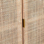 Close-up of a woven beige panel with a gold handle