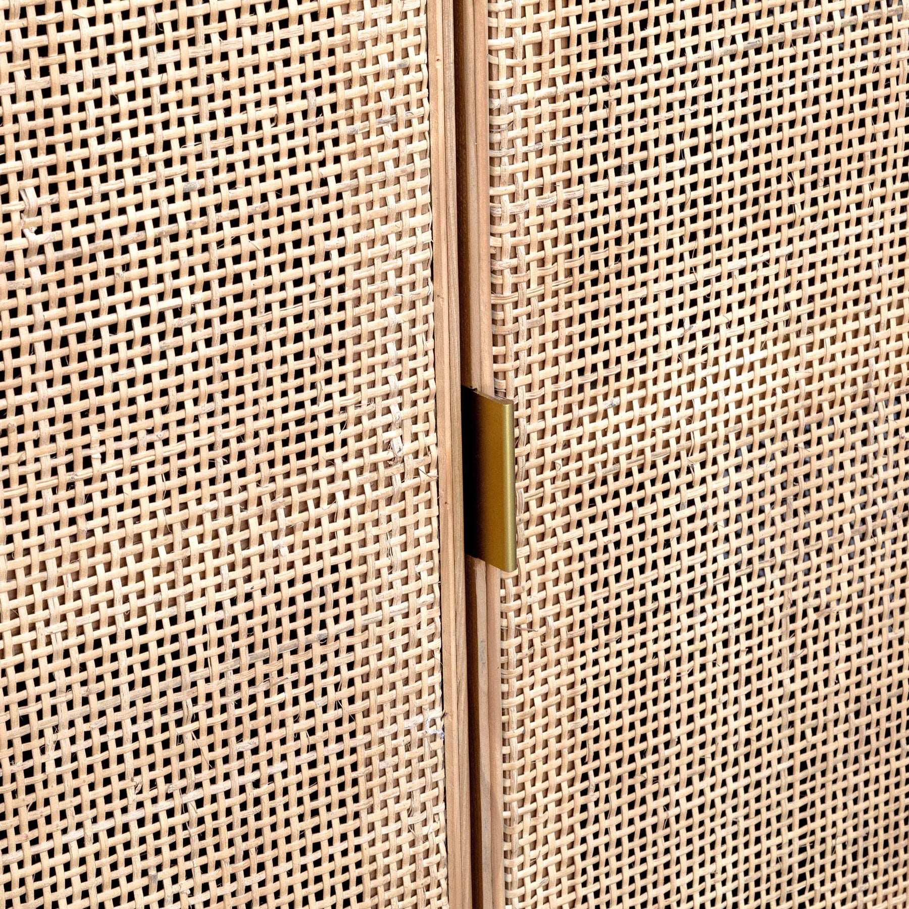 Close-up of a woven beige panel with a gold handle