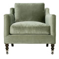 Green velvet armchair with wooden legs on a white background