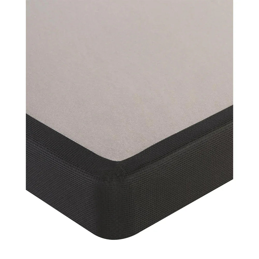 Corner of a mattress boxspring on a white background
