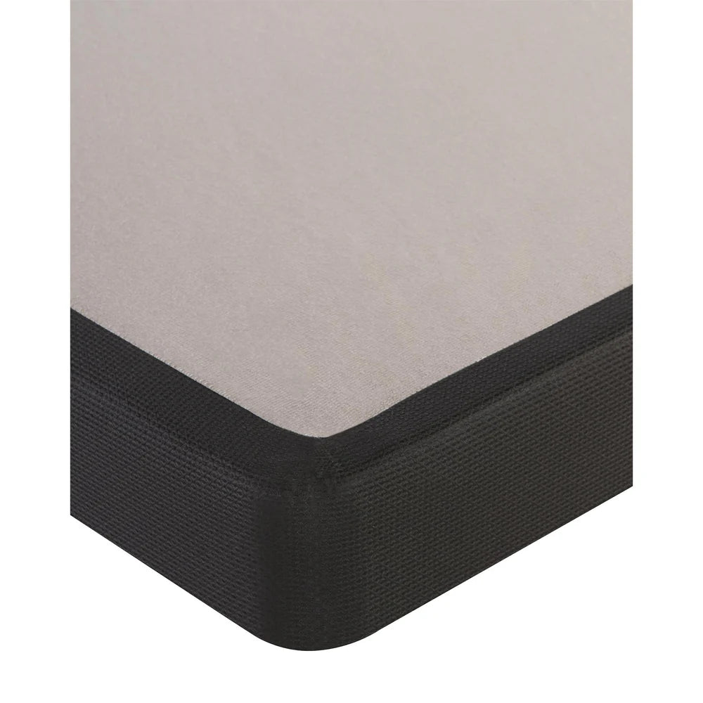 Corner of a mattress boxspring on a white background