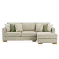 Beige sectional sofa with patterned cushions on a white background